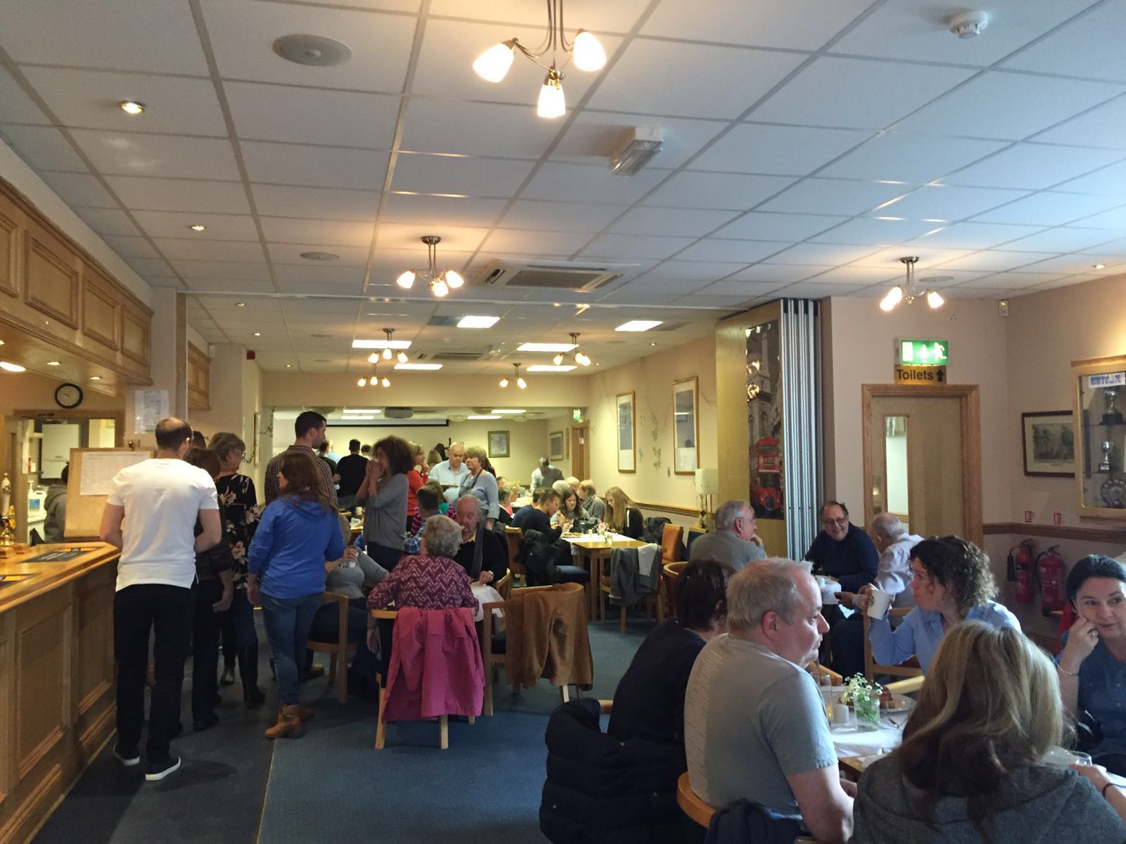 Customers eating food at OVEG's Oxhey Village Big Breakfast on 9 April 2016