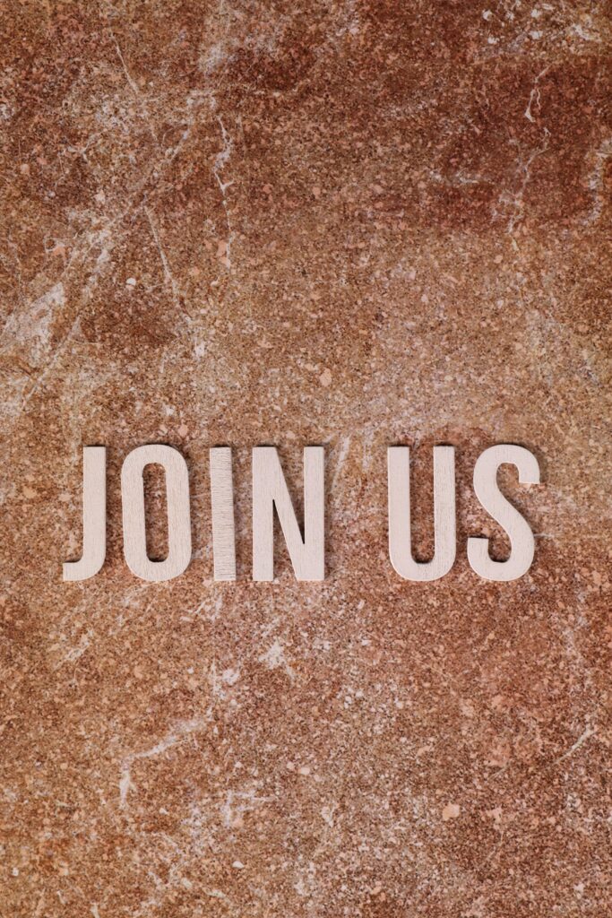 A brown background with the words 'join us'