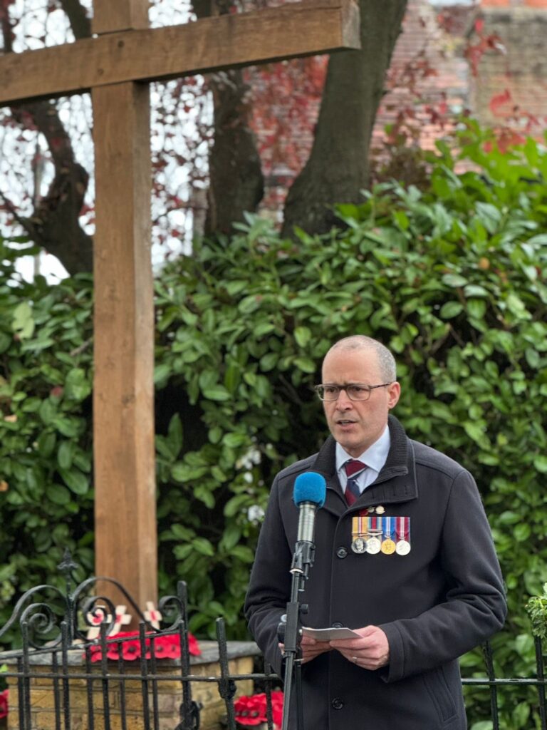 John Ratcliffe speaking at Oxhey Village's remembrance day service on 10 November 2024