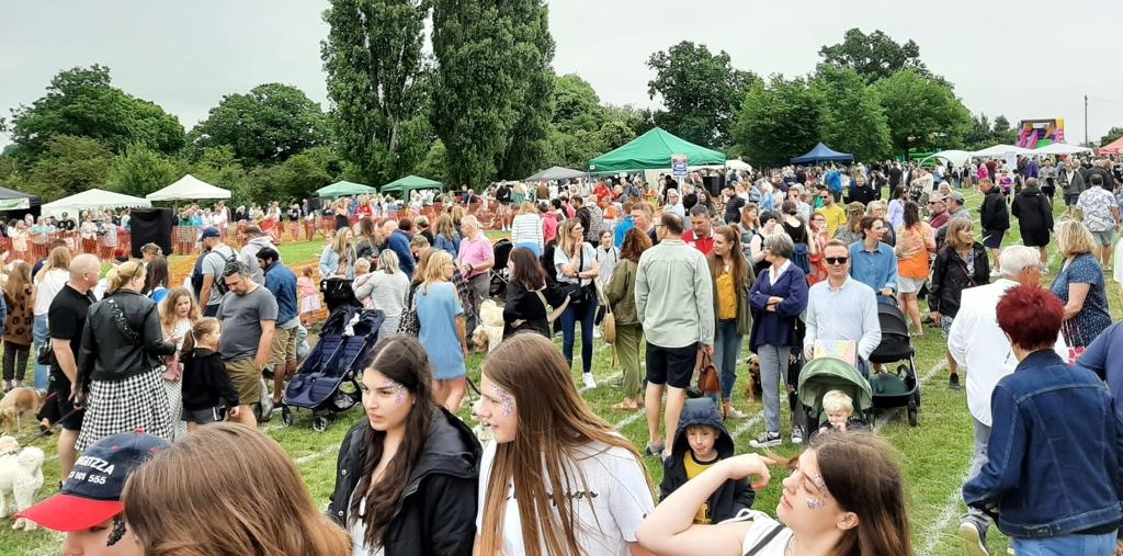 People at the Oxhey Village Summer Fayre on Oxhey Village Green in Watford