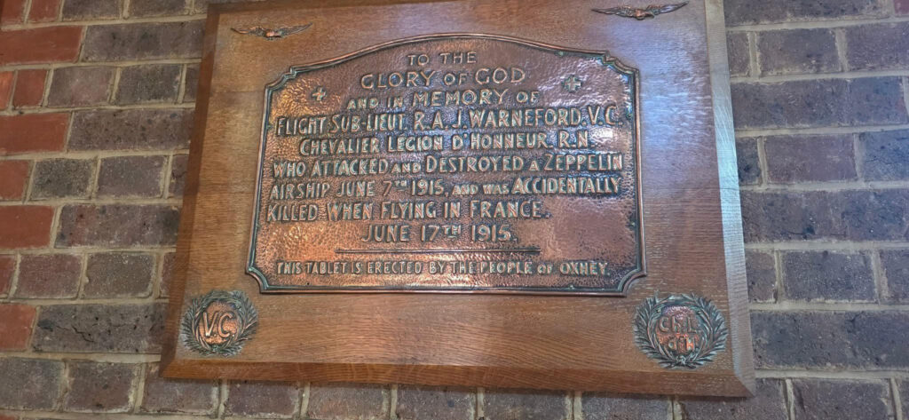 A memorial plaque for Flight Lieutenant Reginald Warneford, located within St Matthews Church in Oxhey Village