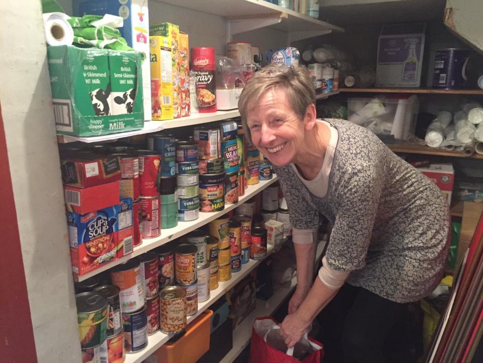 Anne Underwood with food donations at the Red Trust Foodbank in Bushey