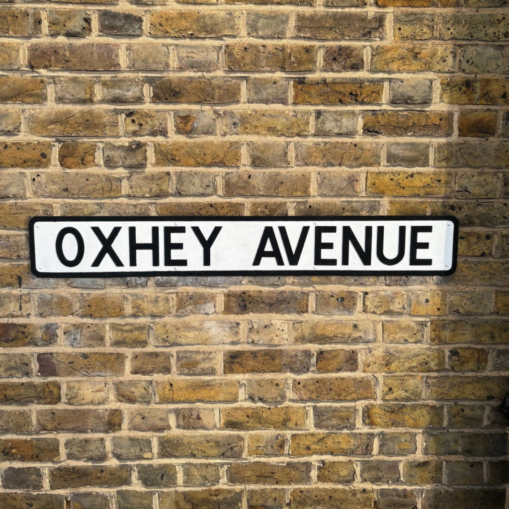 A road sign for Oxhey Avenue in Watford
