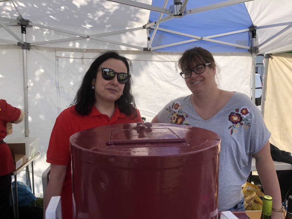 Two women with a tombola stand at OVEG's Oxhey Village Summer Fayre on Saturday 8 June 2019