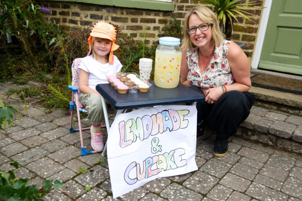 A woman and child selling lemonade and cupcakes at OVEG's Oxhey Village Jumble Trail on Saturday 12 September 2026
